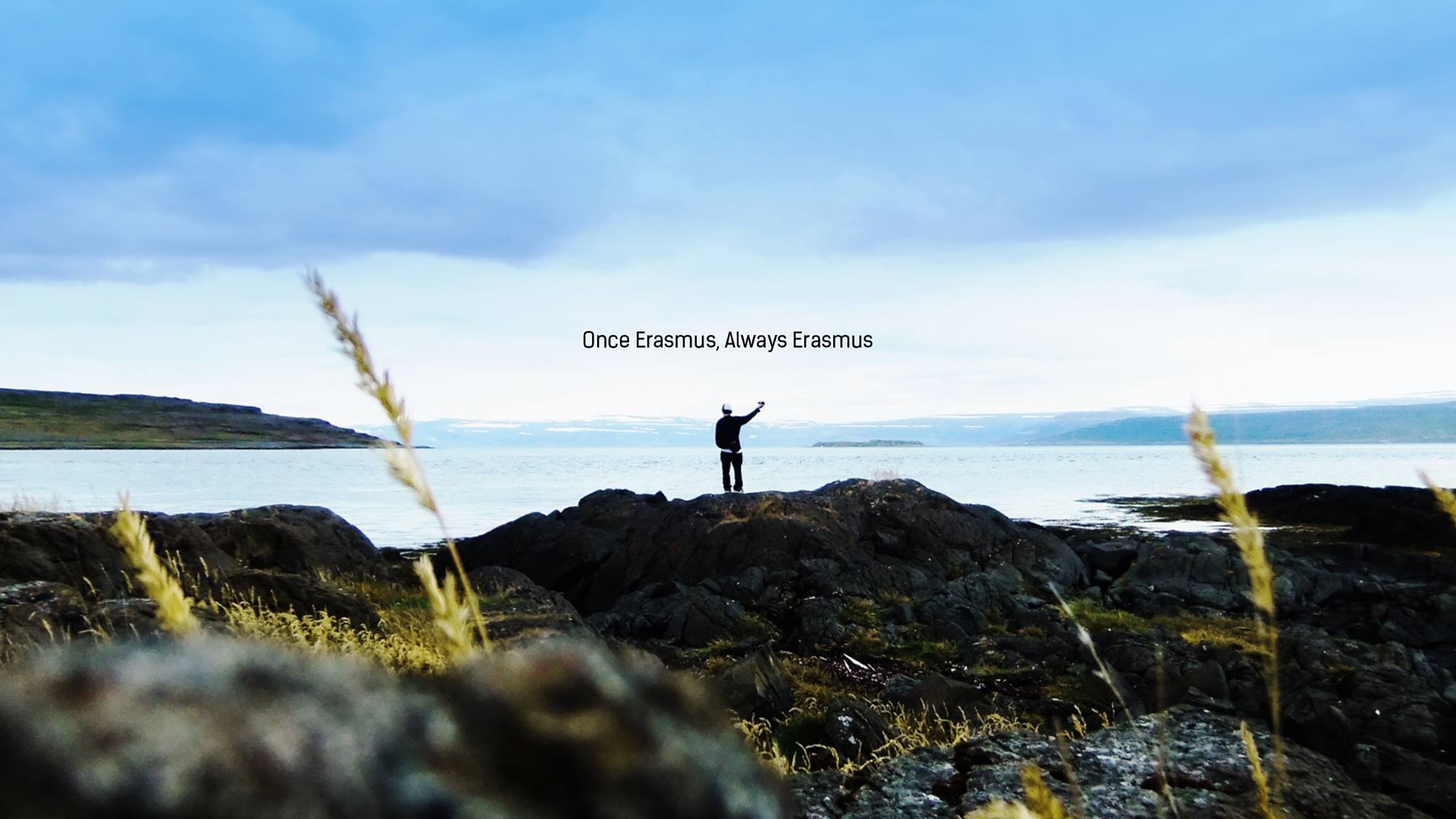 Patrick standing in front of a panoramic view in Iceland. The words "Once Erasmus, Always Erasmus" written over his head.