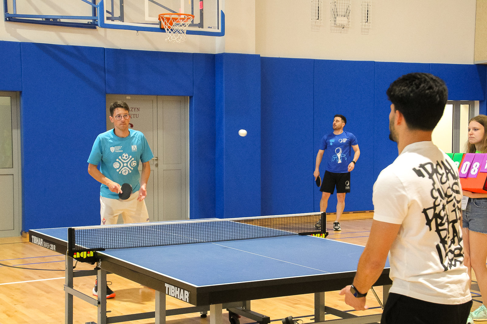 A table tennis match between two people