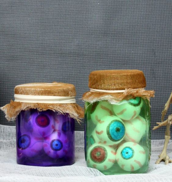 Jars filled with fake eyes made with ping-pong balls for decoration