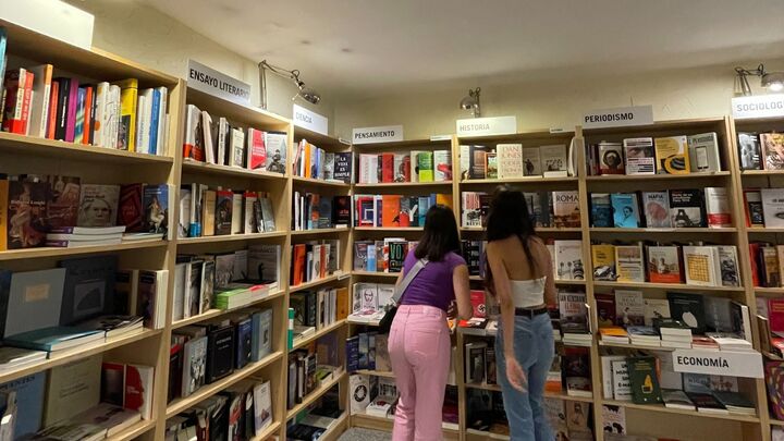 Two girls on a library looking for books