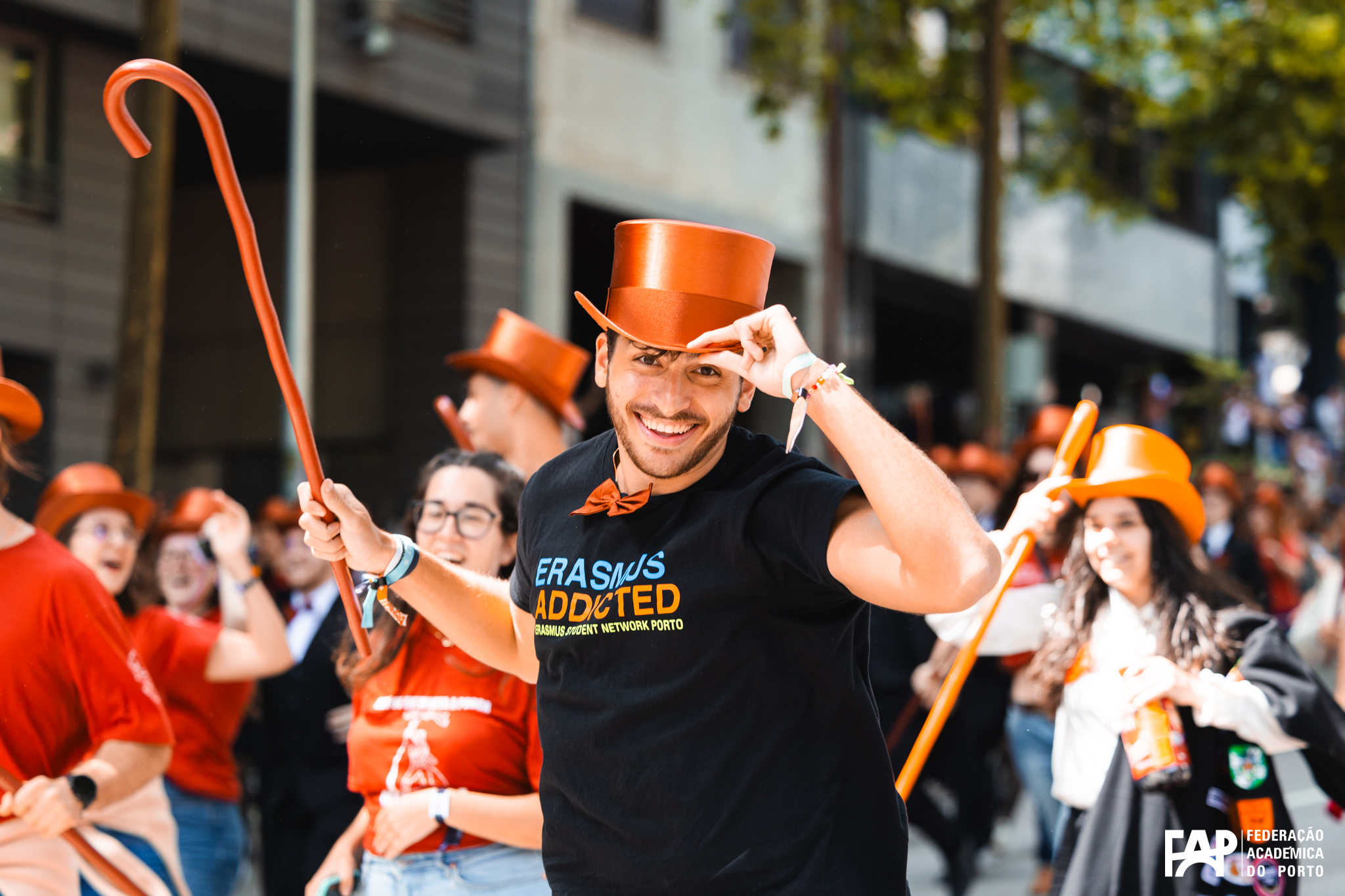 A person with an orange hat and a stick.