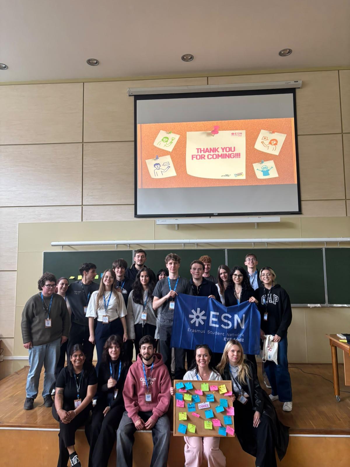 The image shows a group of picture posing for a picture with an ESN flag