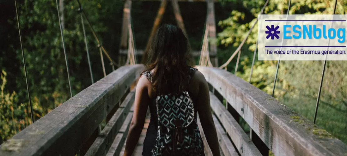 girl crossing a bridge