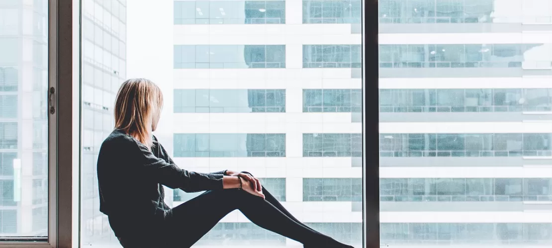 woman sitting on window