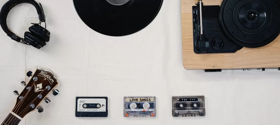vinyl records, player, headphones on white table