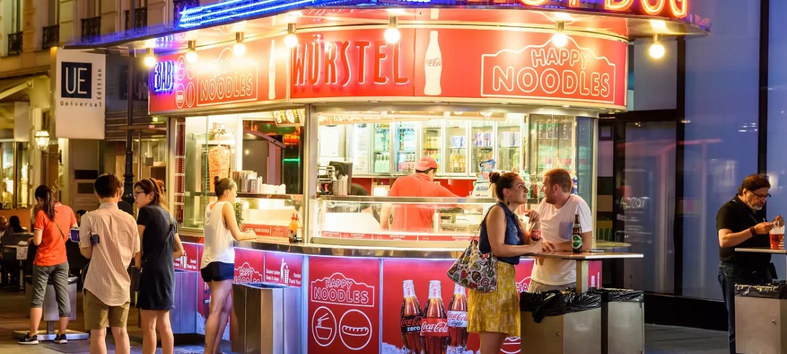 people eating outside in frotn of noodles shop