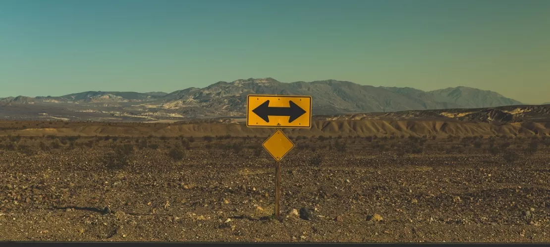 yellow arrow road sign