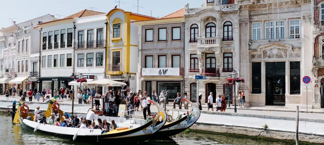 people in boat in front of buildings