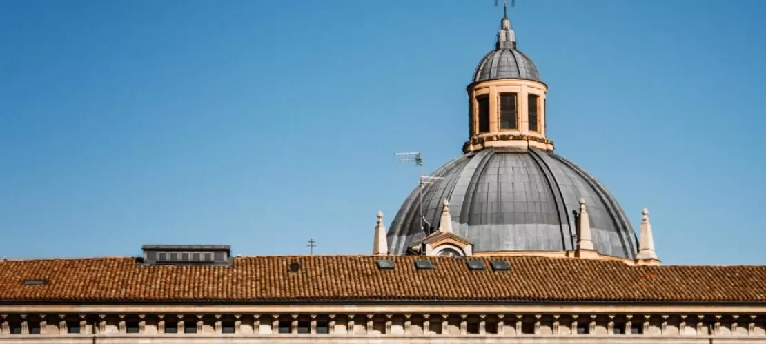 buidling's roof with cathedral's top in the background