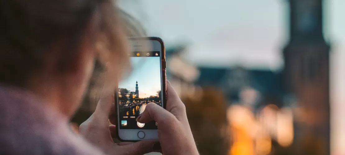 A girl taking a picture of a city