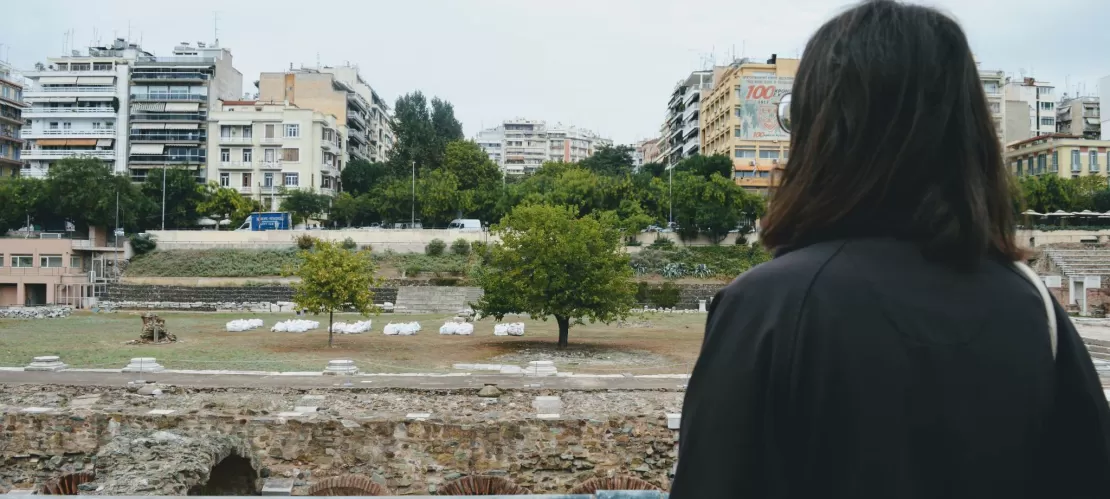 A girl standing and watching the city from a distance