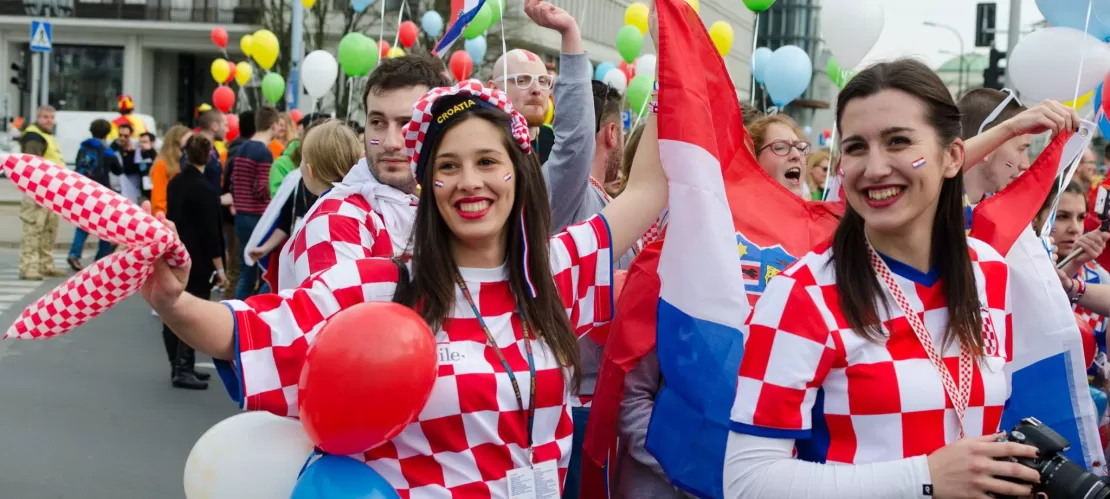 A group of young people dressed in their country's colours.