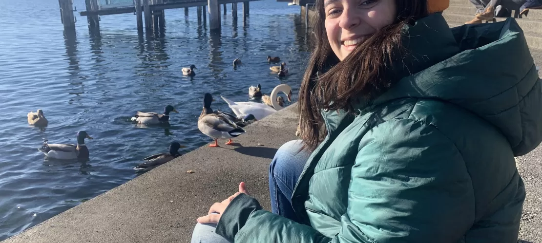 Mariana sitting by Lake Constance, saying goodbye to the ducks.