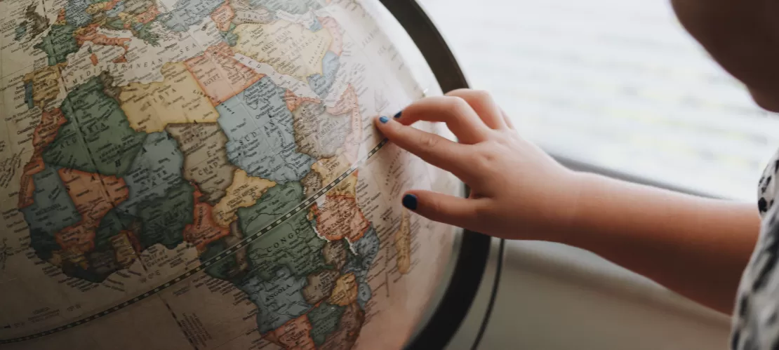 kid checking a globe map