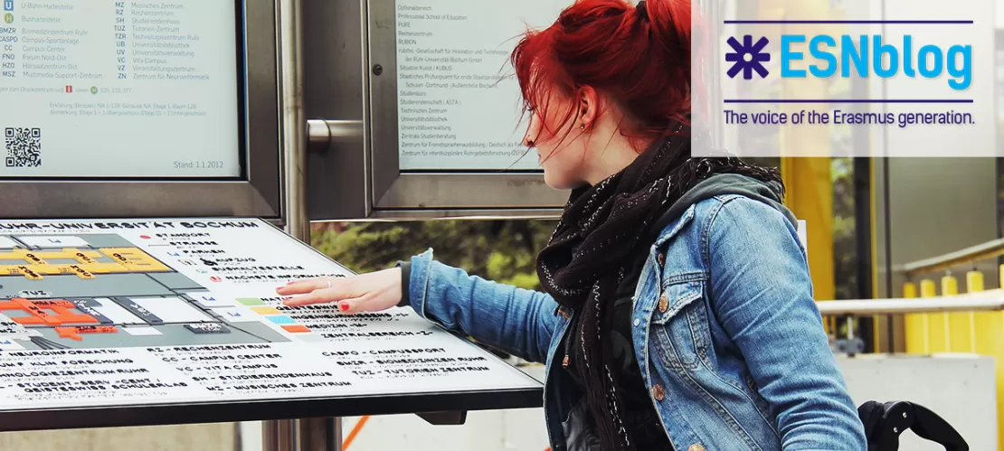 girl on wheelchair looking at a map