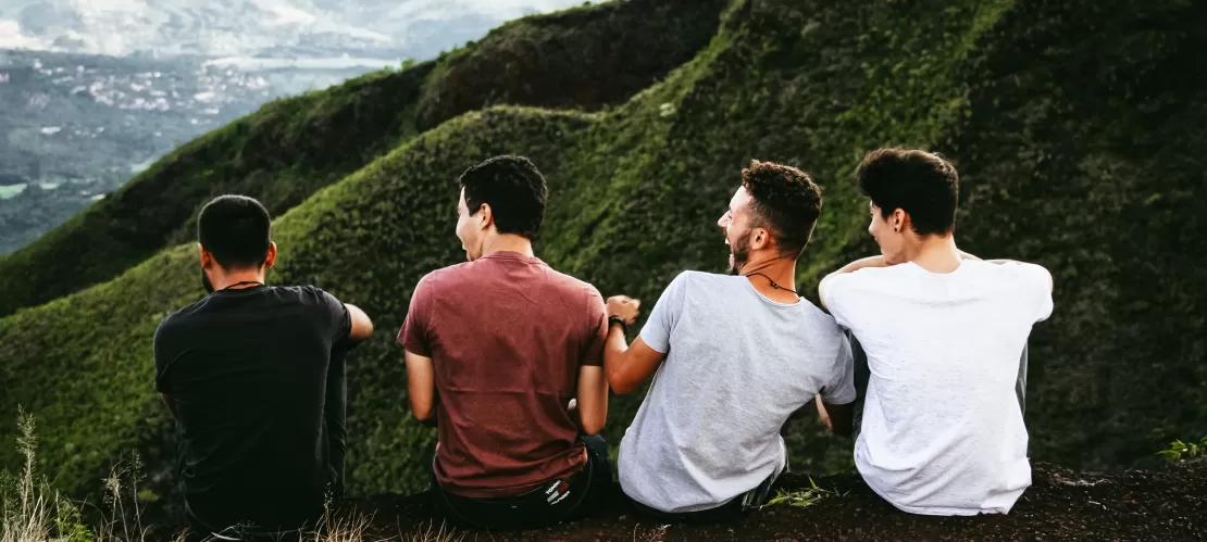 four boys looking at a mountain