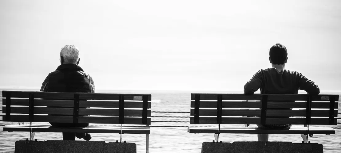 two people sit on benches