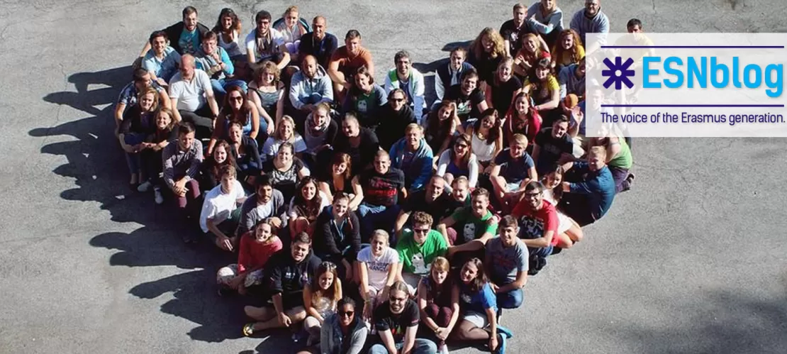 group of people doing a heart