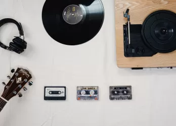 vinyl records, player, headphones on white table