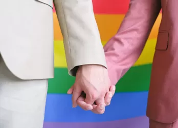 close-up on two persons holding hands