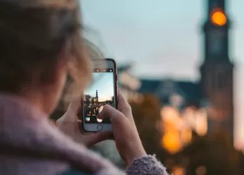 A girl taking a picture of a city