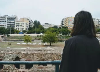 A girl standing and watching the city from a distance