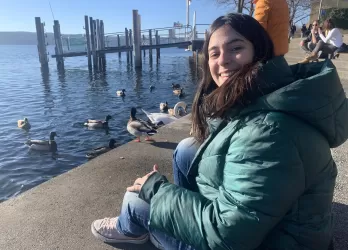 Mariana sitting by Lake Constance, saying goodbye to the ducks.