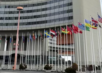 The United Nations building in Vienna with rows of national flags
