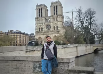 A photo of me standing in front of the Notre Dame Cathedral during my stopover in Paris.