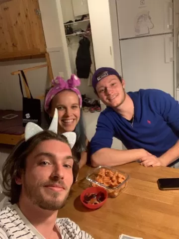 Three people posing to a selfie in a flat