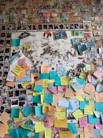 A wall with a map and surrounding sticky notes