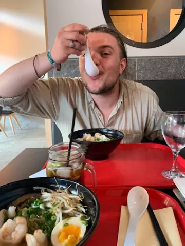 A young man eating ramen