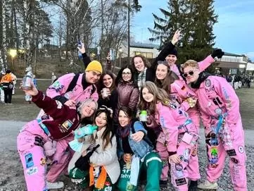 International group of people, wearing pink costumes