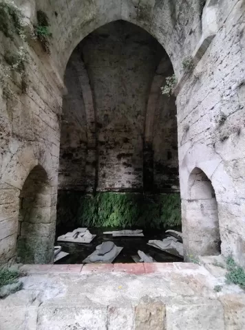 An eerie looking space, with sculptures floating on the water