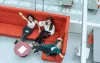 Sana and her friends at the uni, sitting o a couch. Photo taken from above